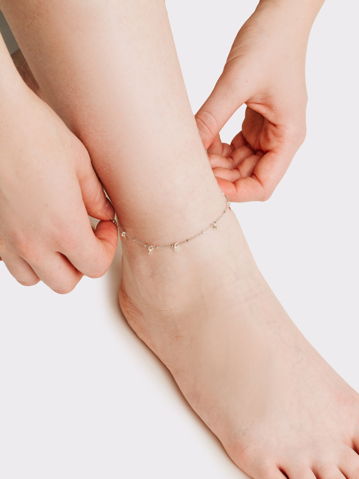 Silver anklet with charms