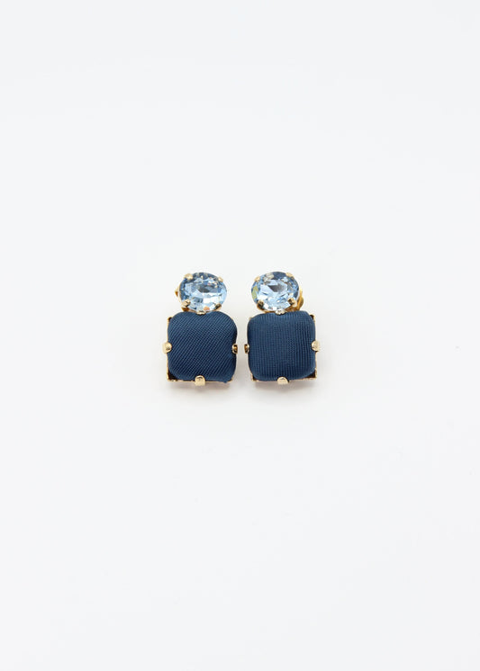 Orecchini blu eleganti fatti a mano da Laura Sciunnach Bijoux, modello Metropolitan Siviglia con bottone quadrato blu notte e cristallo ovale azzurro, design geometrico leggero e raffinato.