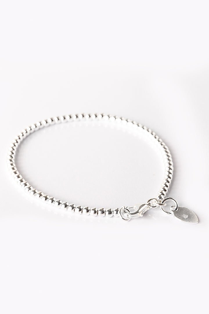 Silver bracelet with small beads and letter