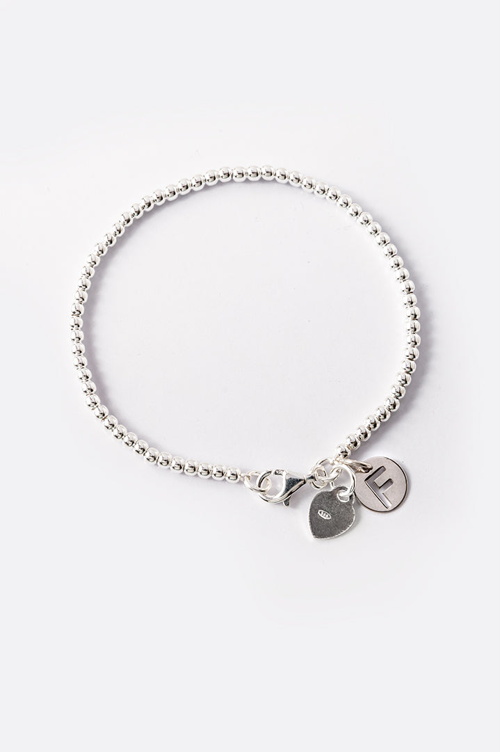 Silver bracelet with small beads and letter